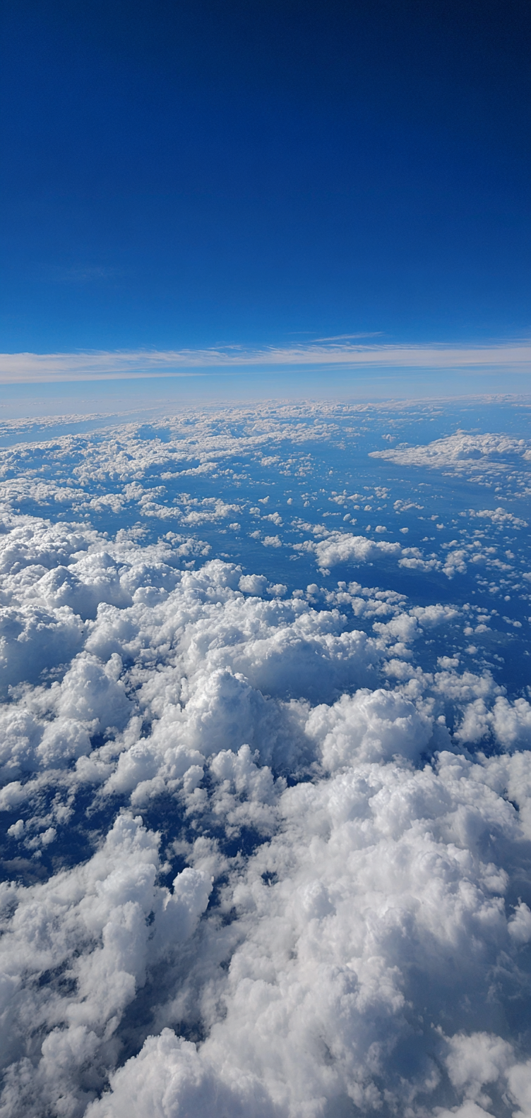 Fluffy white clouds from airplane window view